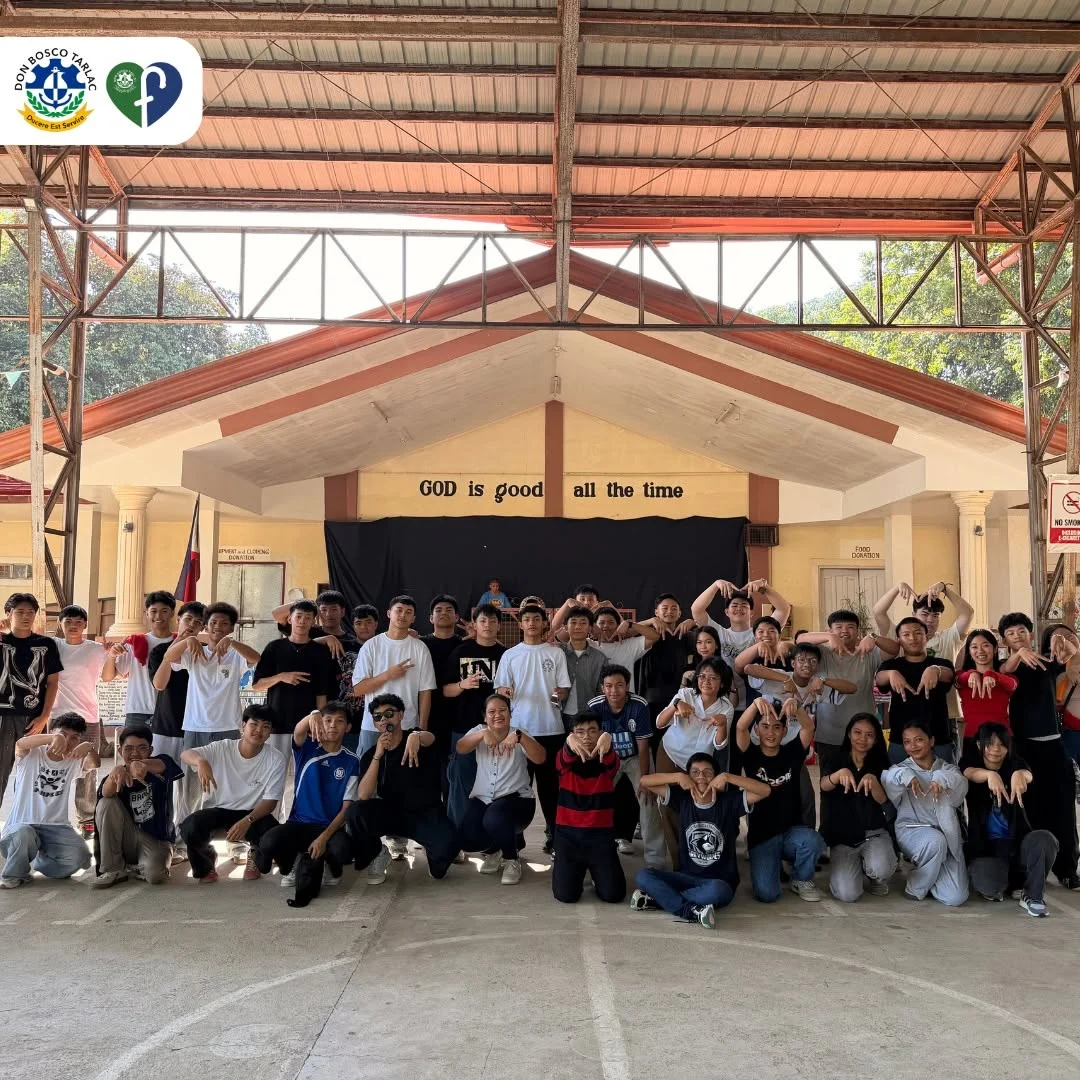 A group poses together in the gathering space at AMOR Village.